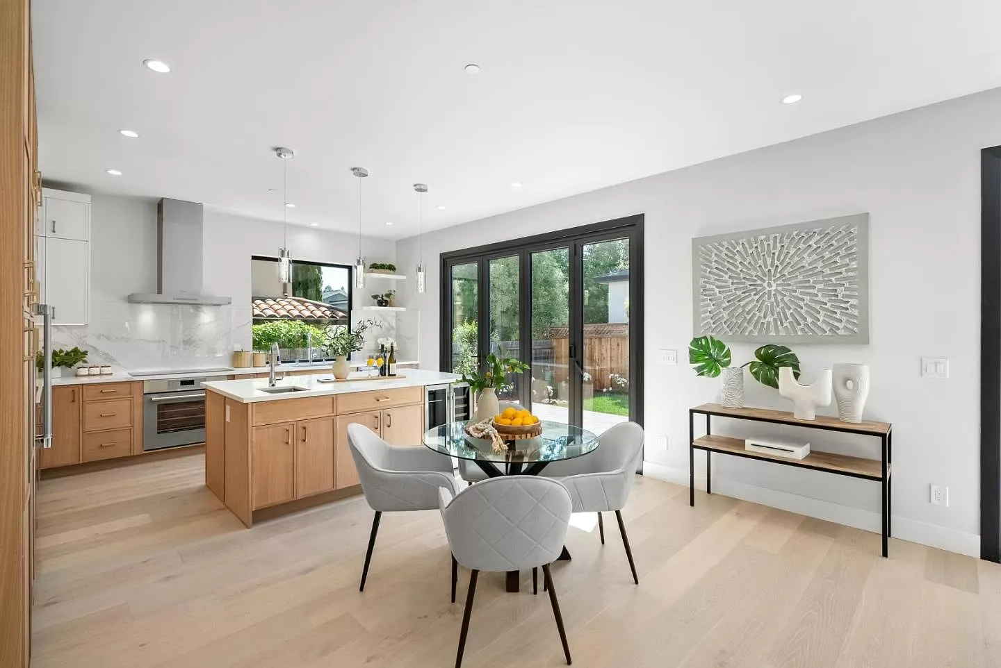 Open kitchen and dining remodel with white oak cabinetry and a glass patio door