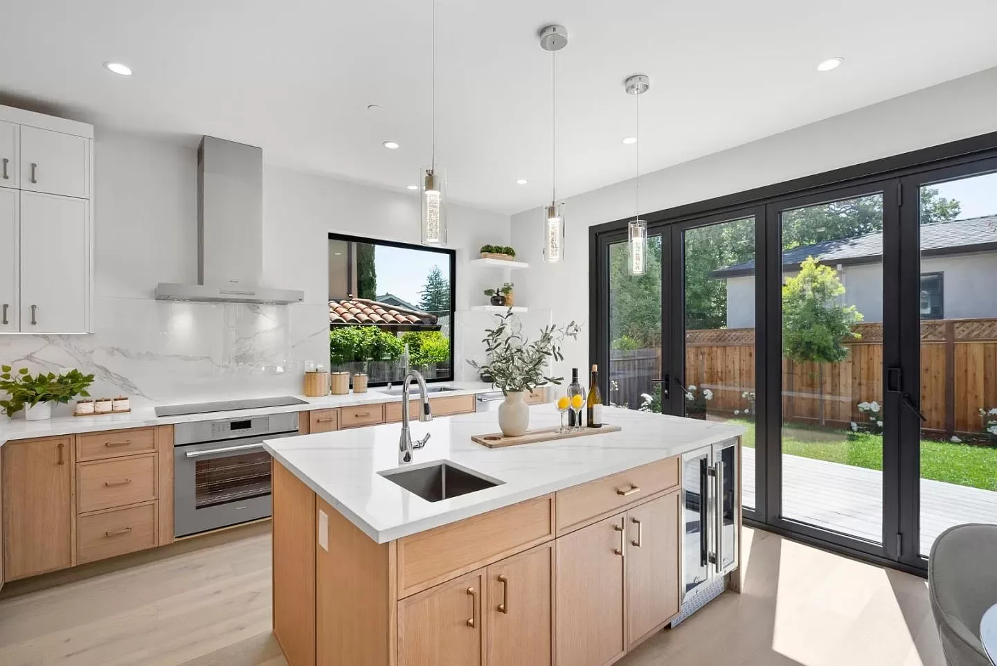 Remodeled kitchen with a wide glass door connecting the island to the patio