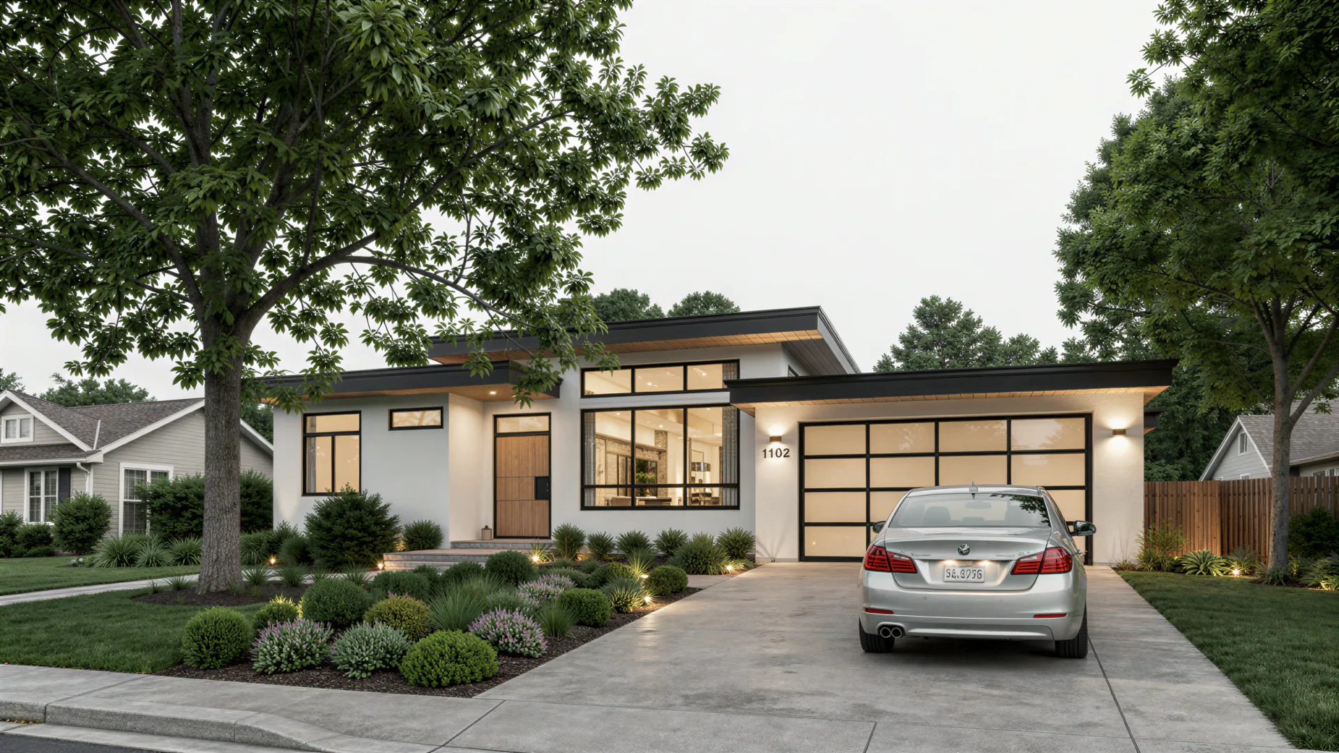 Front exterior of a modern single-story home with flat rooflines, large windows, and an attached garage
