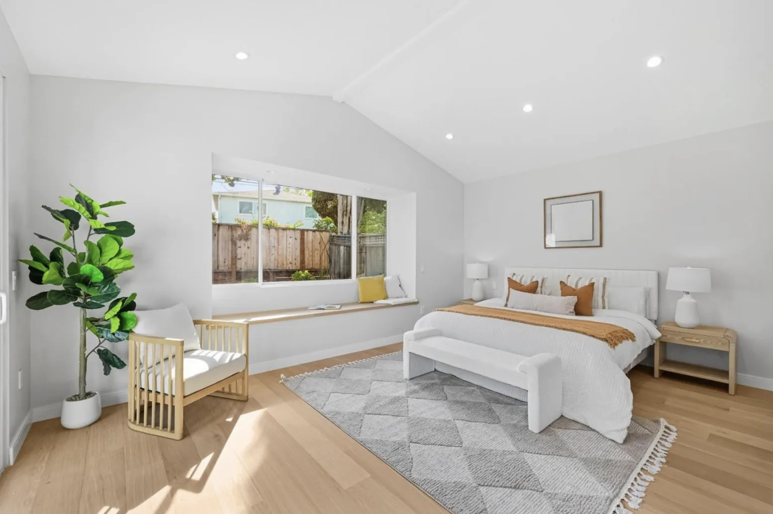 Bedroom remodel with a vaulted ceiling, recessed lighting, and light wood flooring
