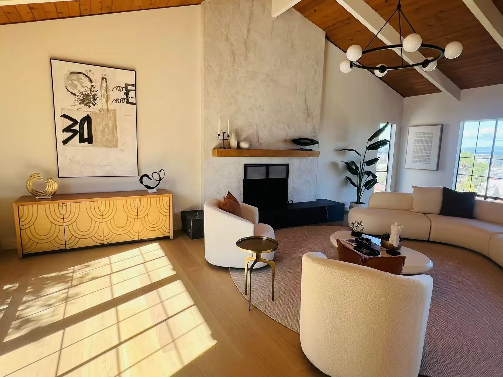 Sunlit living room with a vaulted wood ceiling, exposed beams, and clerestory windows